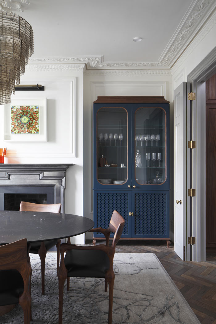 Bespoke cabinetry Hague Blue, with walnut trim detail. Restored cornice and cast iron fireplace, with wall panelling.