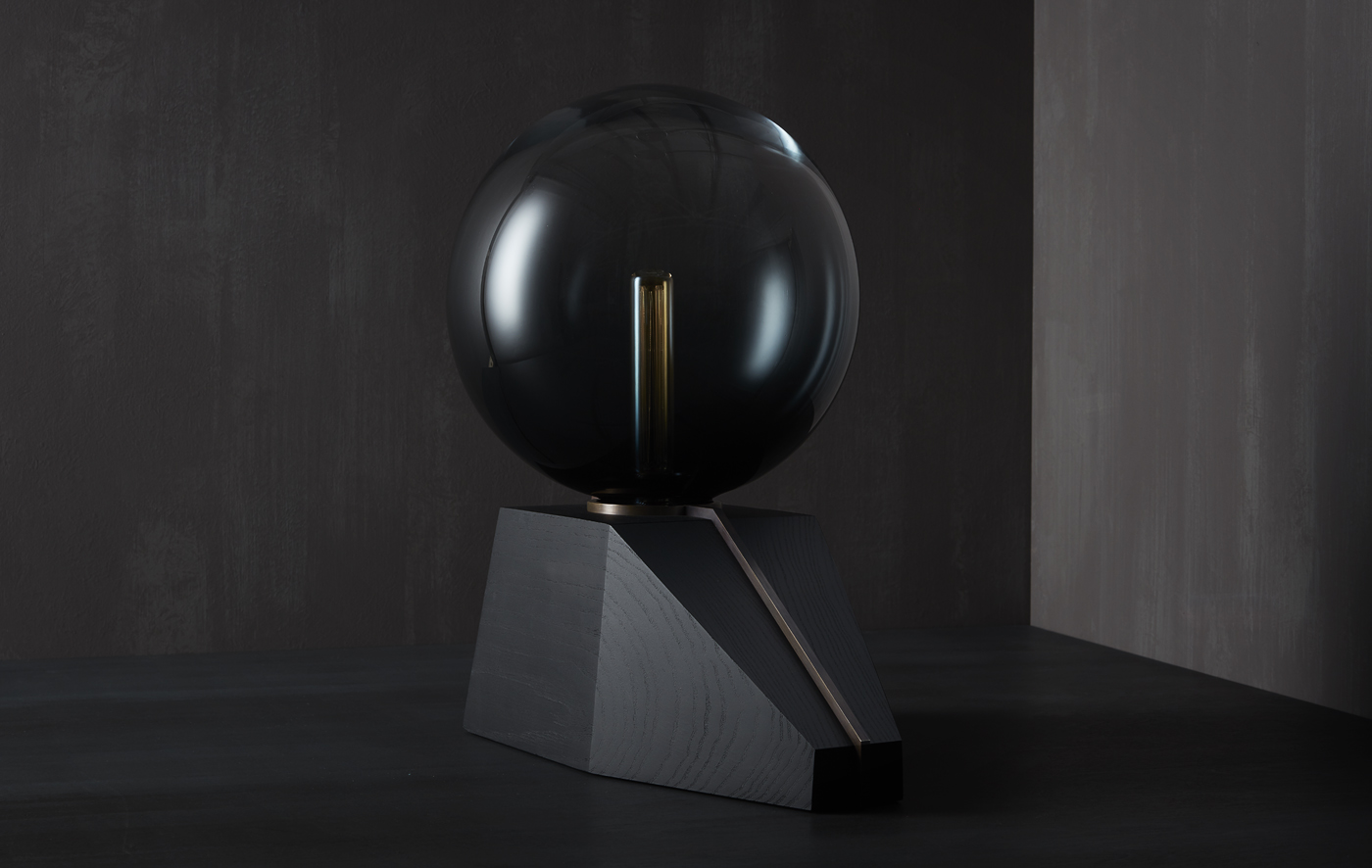 Table lamp with Murano glass globe, blackened ash base and bronze strap detail