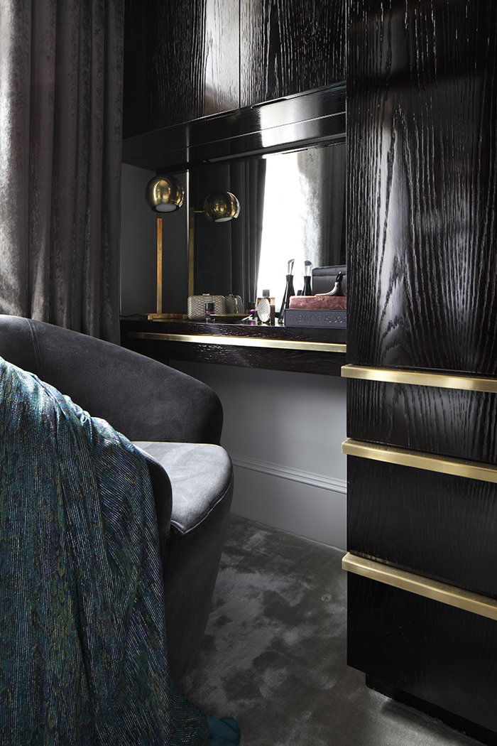 Master bedroom with blackened oak headboard and side units, with brass details. Smoked mirrors and crystal pendant bedside lights.
