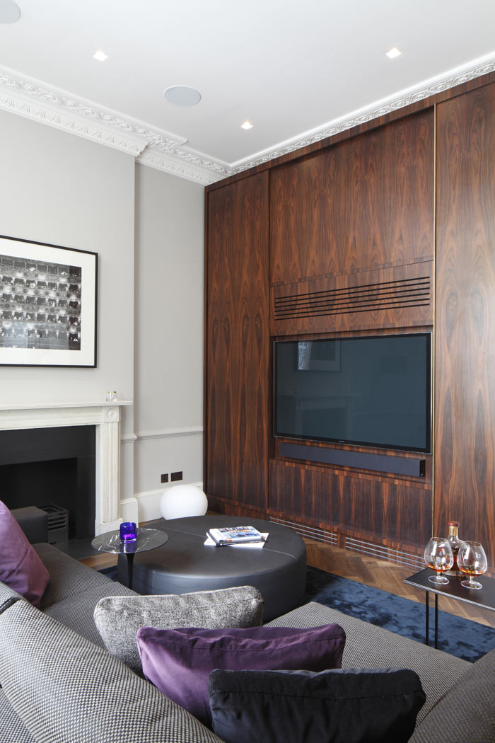 Floor to ceiling Rosewood tv cabinet, with sliding doors and bespoke brass handle detail