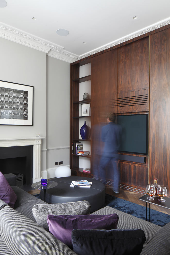 Floor to ceiling Rosewood tv cabinet, with sliding doors and bespoke brass handle detail