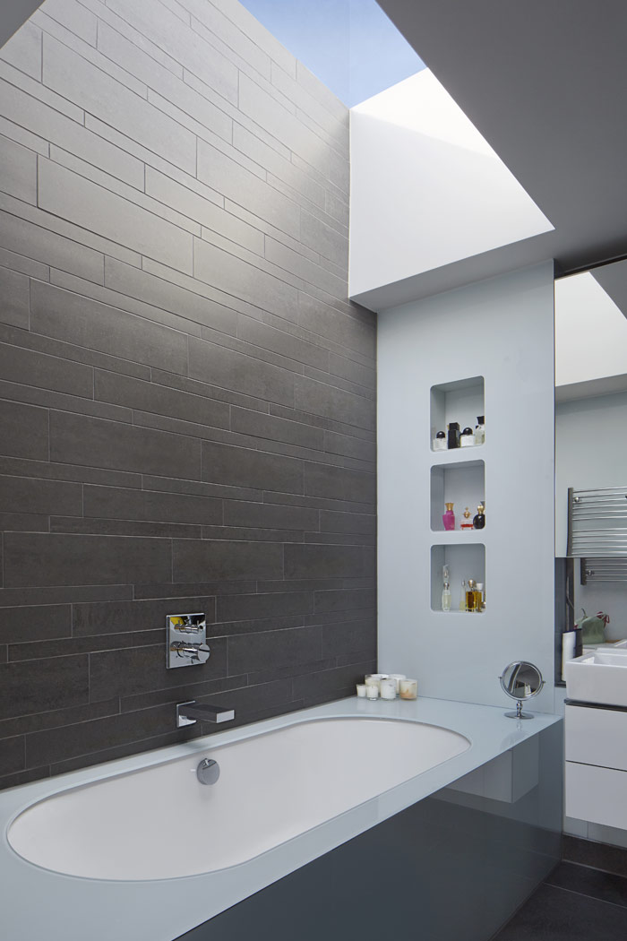 Top lit master bathroom, with skylight above bath and recessed shelf detail.
