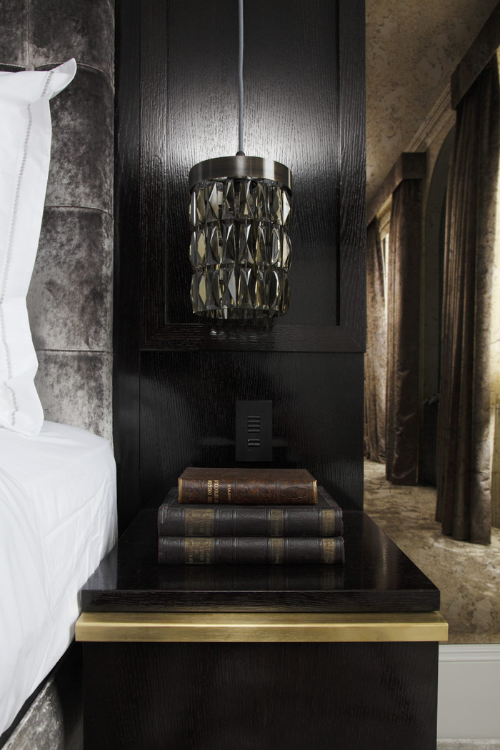 Blackened oak headboard and side units, with brass details. Smoked mirrors and crystal pendant bedside lights.