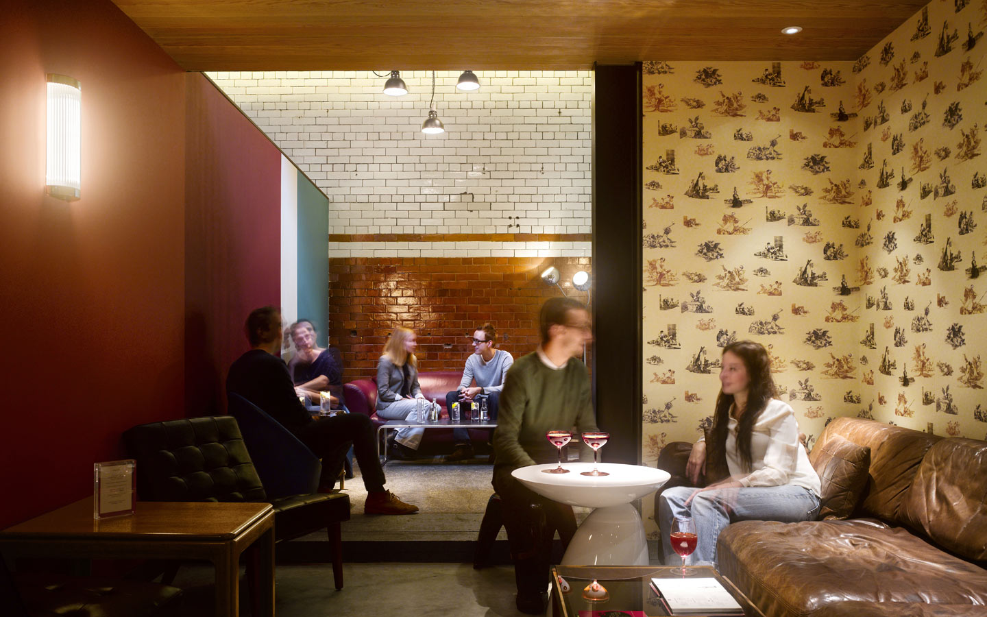 Tramshed Shoreditch, small bar area, with original glazed tiles, timber lined ceiling and The Chapman Brothers wallpaper.