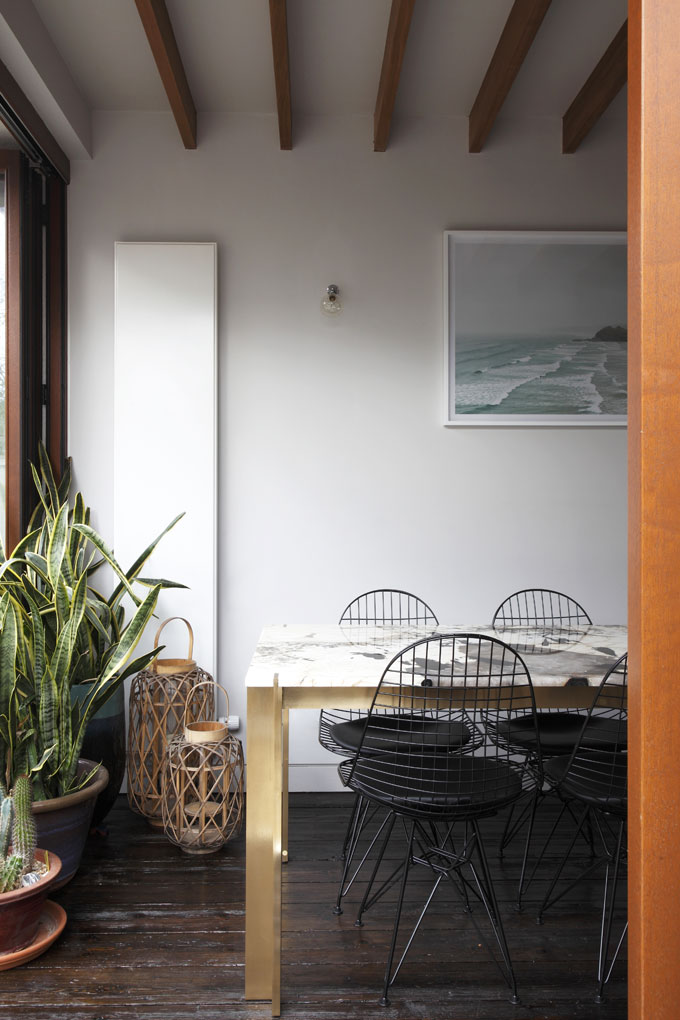 Rear ground floor extension with exposed beams, reclaimed 200 year old timber floor. New Brass Carlo Table by Studioloop, with Patagonia Quartzite top.