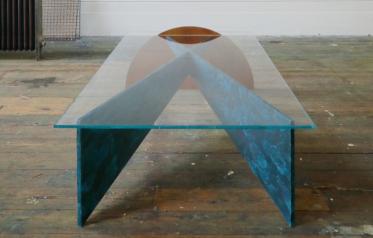 Thonis Table designed by Studioloop Geometric shapes from brass and bronze plate, slot together to form the table structure, with low iron glass top